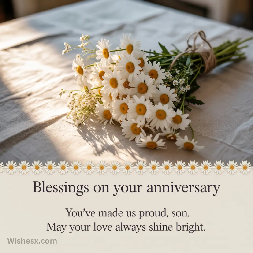A bouquet of daisies lies on a sunlit table, casting soft shadows. Below, text reads: "Blessings on your anniversary. You’ve made us proud, son. May your love always shine bright."